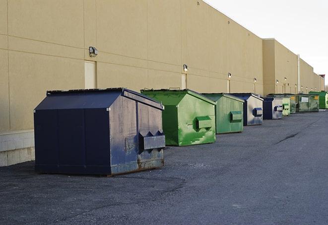 an assortment of sturdy and reliable waste containers near a construction area in Needham Heights, MA